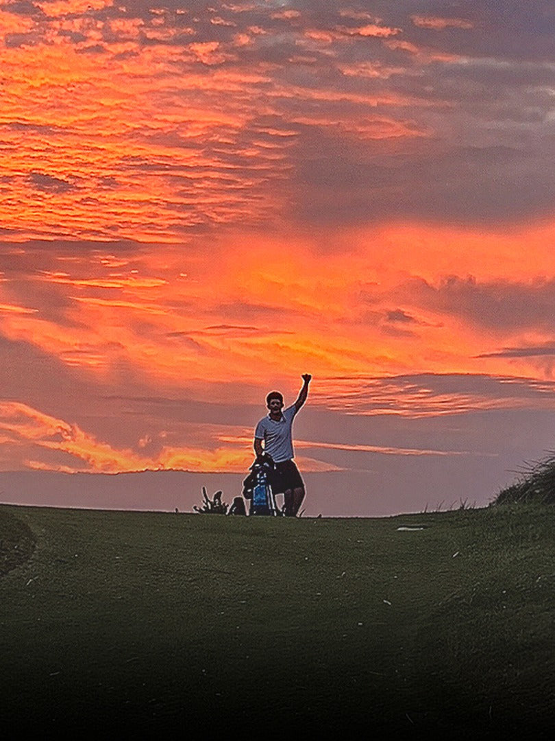 Kevin celebrating on the course at sunset