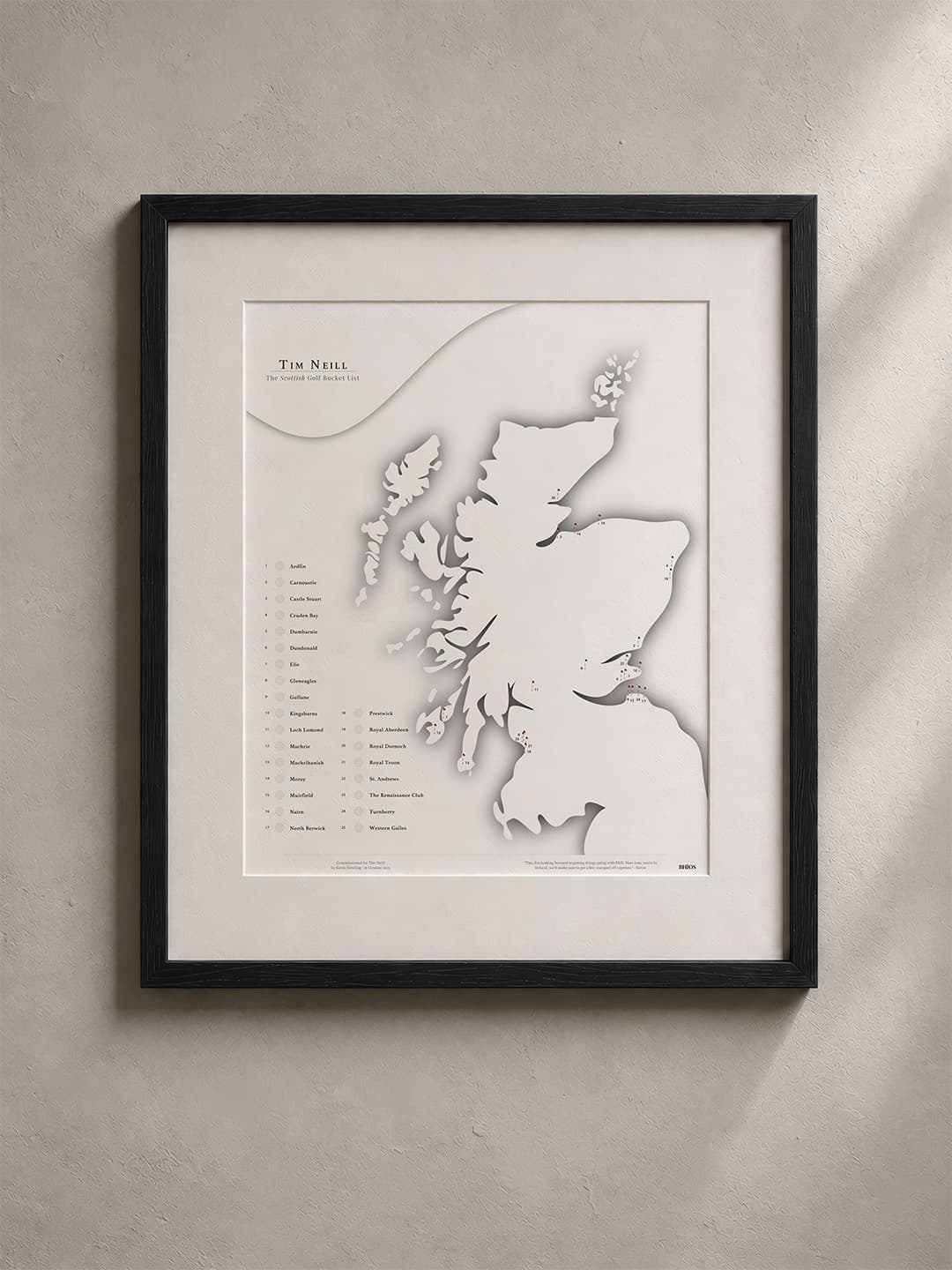 A framed BHÍOS map of Scotland's golf courses in a solid black timber frame.